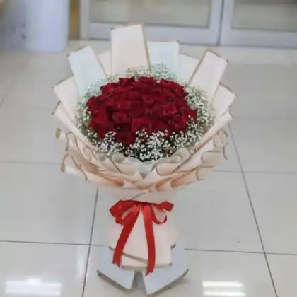 A stunning 18 roses bouquet of fresh red blooms elegantly arranged for a romantic surprise.