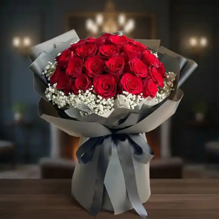 Velvety 24 Red Roses Bouquet 1 Hand-tied 24 red rose bouquet with lush green foliage arranged in a premium floral wrap for a romantic gift.