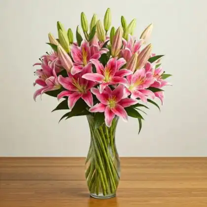 A hand-tied stargazer and calla lily bouquet with vibrant pink petals and elegant white blooms against a soft background.