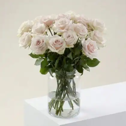 A beautifully arranged white rose bouquet with fresh green foliage, perfect for weddings or elegant home decor.