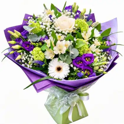 A beautifully hand-tied floral arrangement of crisp white rose and gerbera bouquets set against a soft background.
