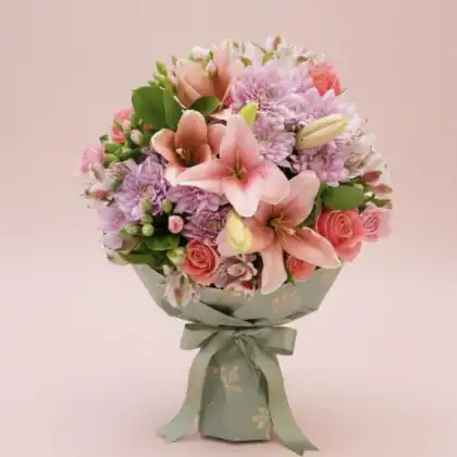 A hand-tied chrysanthemum and lily bouquet featuring vibrant pink petals and fresh white blossoms in a decorative wrap.
