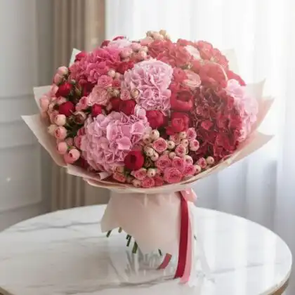 A luxury hydrangea and rose bridal bouquet featuring soft pink petals and elegant greenery for a classic wedding look.
