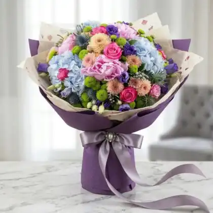 A stunning Peony and Hydrangea Bridal Bouquet with soft pink blooms and lush greenery for a summer wedding.