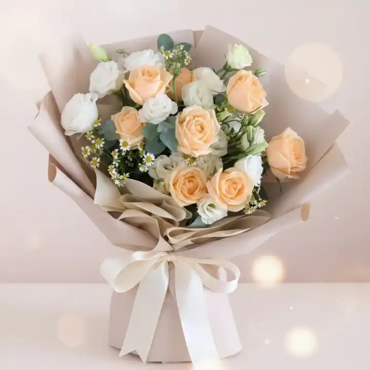 Graceful Peach & Ivory Rose Luxe Bridal Bouquet 1 A stunning pink and white rose bridal bouquet accented with fresh green leaves for a classic wedding ceremony.