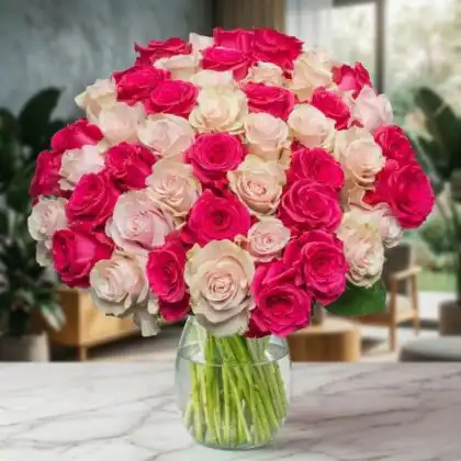 A hand-tied white and pink roses bouquet accented with lush green foliage in a soft paper wrap.