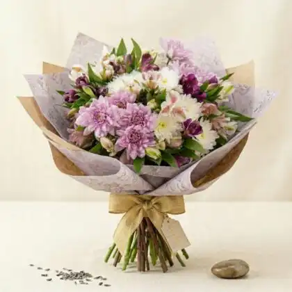 Hand-tied white and pink chrysanthemum bouquet paired with delicate alstroemeria blossoms in a decorative wrap.