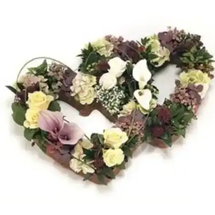 A serene arrangement of double open heart funeral flowers with elegant white and pink blossoms for a memorial service.