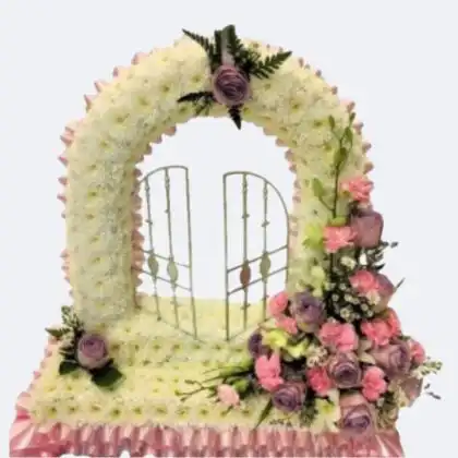 A beautiful Gates of Heaven Funeral Flowers arrangement featuring white roses and lilies, symbolizing peace for a memorial service.