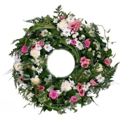 A lush green funeral wreath elegantly arranged with serene pink and white roses to honor a loved one's memory.