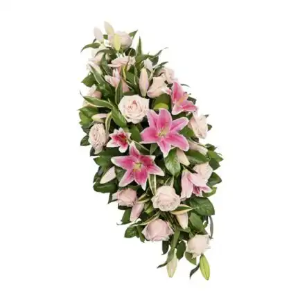 Elegant Coffin Floral Spray featuring fresh pink lilies and roses arranged as a timeless funeral tribute.