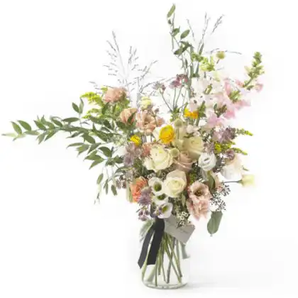 A beautiful white rose flower bouquet arranged with green leaves in a rustic style