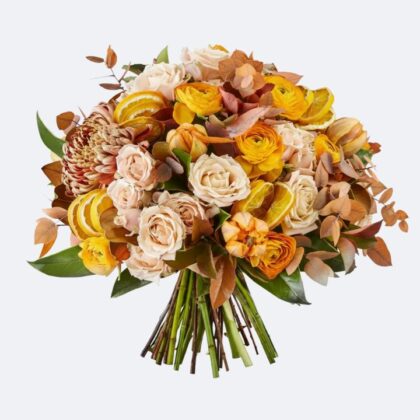 A luxury Ranunculus and Rose Bouquet featuring cream roses, vibrant orange ranunculus, and dried citrus slices in a hand-tied arrangement.
