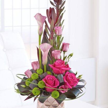 Elegant pink rose and calla lily floral arrangement in a vase