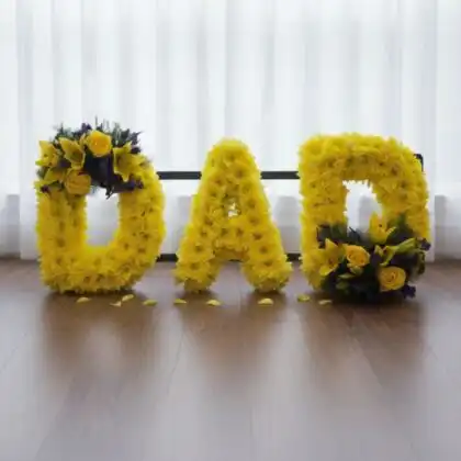 A vibrant dad funeral tribute flowers arrangement featuring colorful blossoms professionally styled for a memorial service.