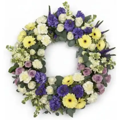 A beautiful floral wreath funeral arrangement featuring fresh lavender and roses to honor a loved one's memory.
