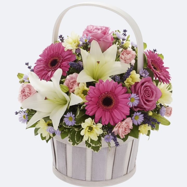 Gerbera Lilies Roses Basket Arrangement 1 A Gerbera Lilies Roses Basket with pink blooms and white lilies in a rustic wooden handle basket.