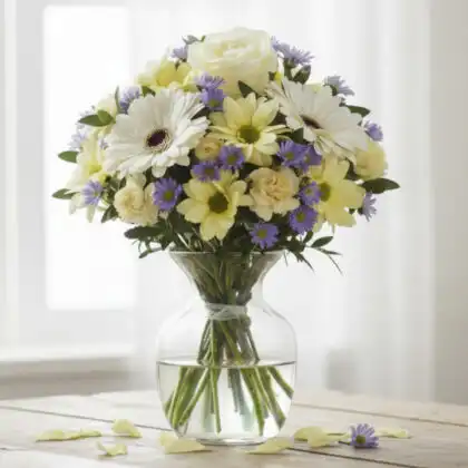 A vibrant pink roses and daisies bouquet arranged with fresh greenery in a decorative wrap.