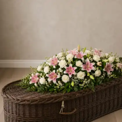 Graceful White Rose and Pink Lily Coffin Spray on a coffin