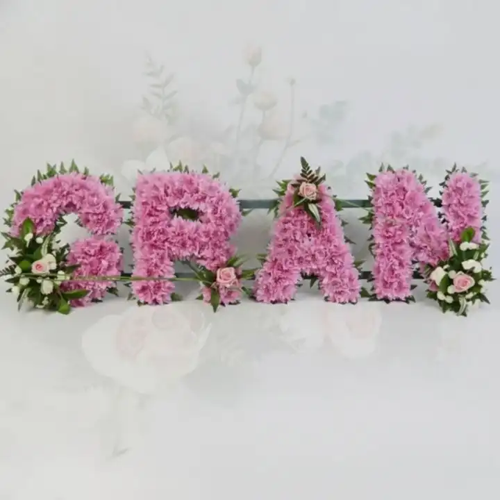 Loving Gran Floral Letter Tribute 1 A beautiful floral letter tribute spelling GRAN made of white chrysanthemums and pink roses for funeral services.