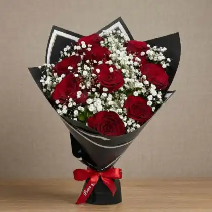 A stunning 13 roses bouquet of deep red blossoms wrapped in elegant florist paper for a romantic gesture.