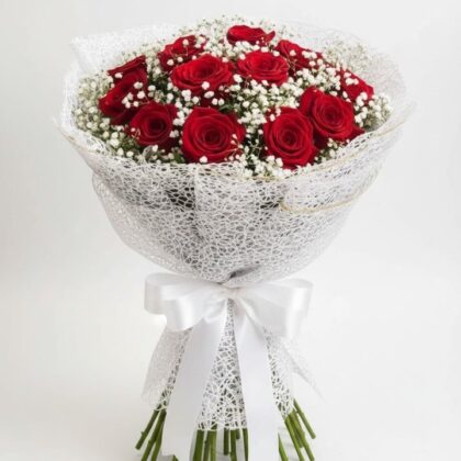 A vibrant 16 rose bouquet featuring deep red petals nestled in white baby's breath and elegant lace wrapping.