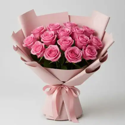 A lush 24 pink roses bouquet wrapped in soft pink paper with a decorative satin ribbon.