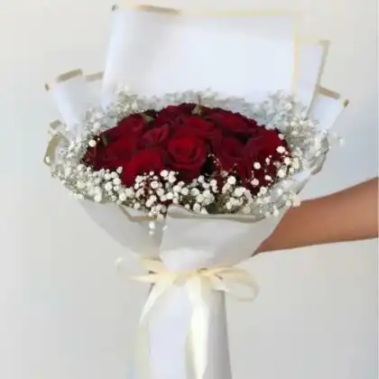 A hand-tied 25 red roses bouquet wrapped in elegant paper for a luxury floral presentation.