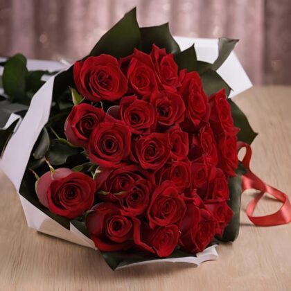 A hand-tied 25 flower bouquet of fresh red roses wrapped in premium white and black paper with a silk ribbon.