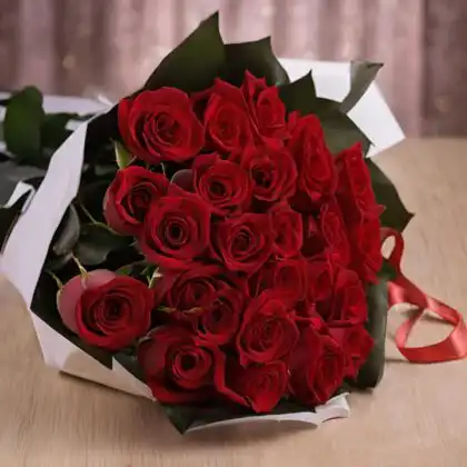 A hand-tied 25 flower bouquet of fresh red roses wrapped in premium white and black paper with a silk ribbon.