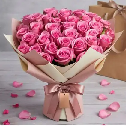Hand-crafted 50 pink roses bouquet with lush greenery in a premium luxury wrap.