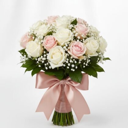 A handcrafted White and Light Pink Rose Bouquet featuring dense rose blooms accented with baby's breath and green leaves.