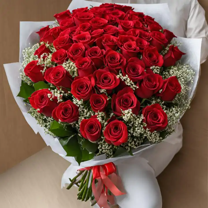 Large Bouquet of Red Roses in White Wrapping 1 A large bouquet of red roses accented with white baby's breath and wrapped in premium white floral paper.