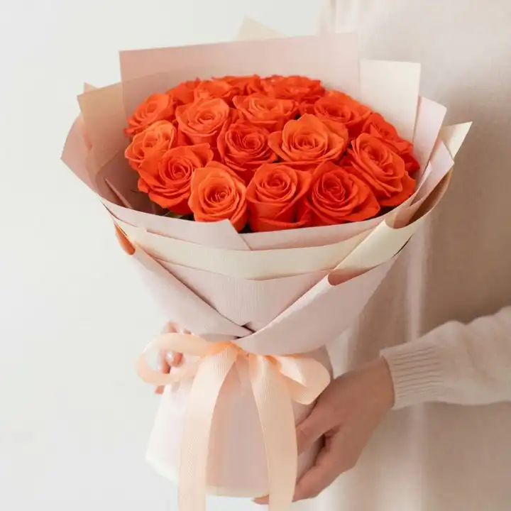 Elegant Orange Rose Flower Bouquet 1 Hand-tied orange rose bridal bouquet wrapped in premium paper with a soft peach ribbon for wedding ceremonies.