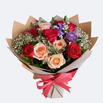 A luxury Peach and Red Rose Bouquet with purple lisianthus and white baby's breath wrapped in premium craft paper.