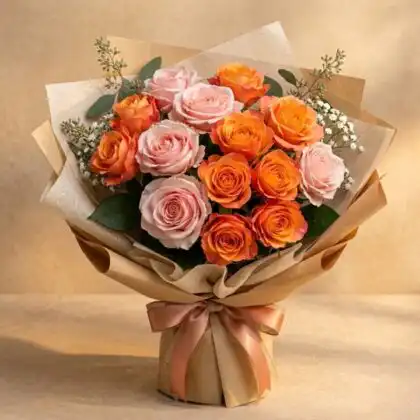 A fresh Pink and Orange Flower Bouquet arranged with greenery in a stylish wrap for a vibrant gift.