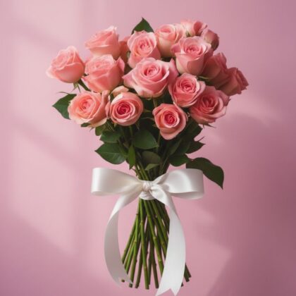 A handcrafted premium bouquet roses pink tied with a white satin ribbon against a soft pastel background.