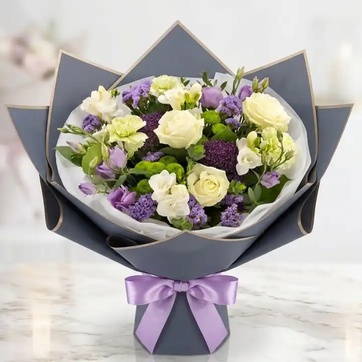 White Rose & Green Carnation Dream Bouquet 1 A hand-tied white rose and carnation bouquet accented with lush green foliage in a minimalist setting.