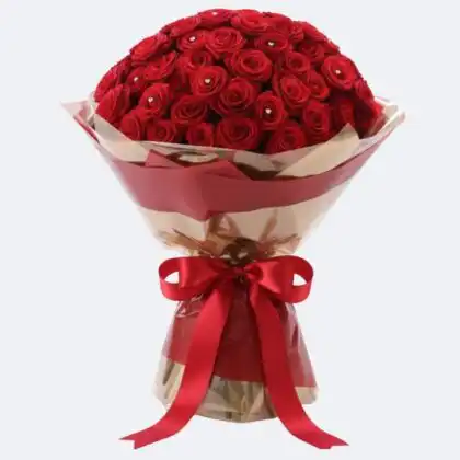 A stunning hand-tied bouquet of 50 luxury red roses with fresh green leaves, ideal for a grand romantic gesture.