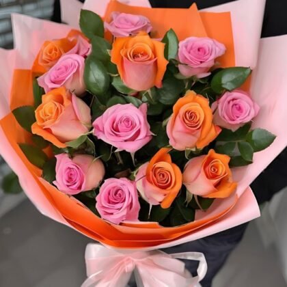 Pink And Orange Rose Bouquet Mothers Day Flowers held by a man