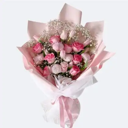 A romantic Tulip and Rose Bridal Bouquet featuring blush pink petals, peonies, and delicate white gypsophila.