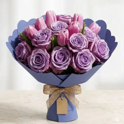 Hand-tied bouquet of roses and tulips featuring soft lilac petals and vibrant pink blooms in a stylish arrangement.