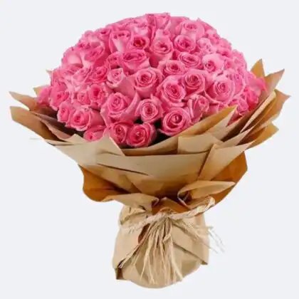 A large Luxury Pink Rose Bouquet wrapped in brown kraft paper with a natural twine bow.