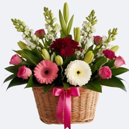 A lush Roses and Gerbera Arrangement featuring pink blooms and white daisies in a woven basket with a pink ribbon.