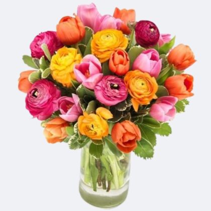 A lush arrangement of vibrant tulips and ranunculus gathered in a decorative vase for a bright floral display.