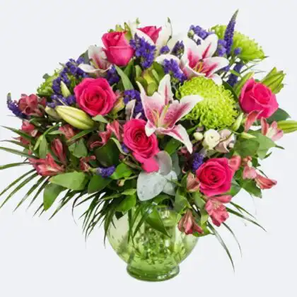A beautiful arrangement of fresh pink roses and lilies vase placed on a table for interior decoration.