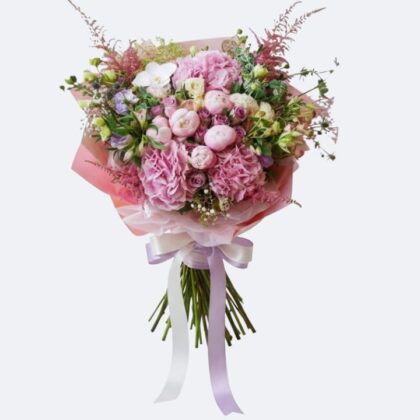 A lush Spring in Pink – Peony, Hydrangea & Orchid Bouquet featuring vibrant pink blooms and fresh greenery.