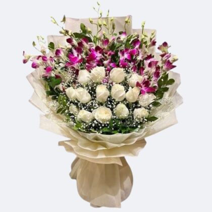 A hand-tied White Roses and Purple Orchid Bouquet wrapped in cream paper, featuring fresh blooms and baby's breath.