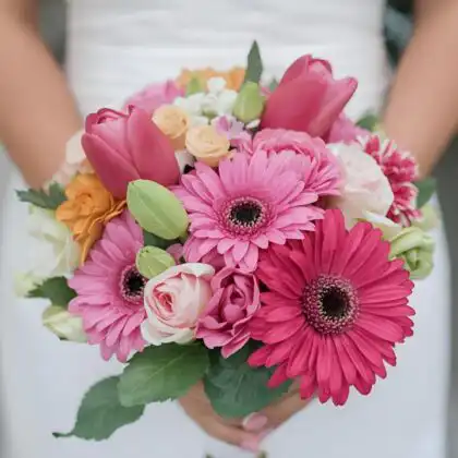 Close-up of a stunning Pink Ranunculus Bridal Bouquet featuring vibrant pink gerbera daisies, pink tulips, and delicate ranunculus, perfect for a wedding.