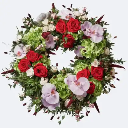 Luxury Sympathy Funeral Wreaths crafted with vibrant red roses, large pink Phalaenopsis orchids, and lush green hydrangeas for a distinguished memorial.